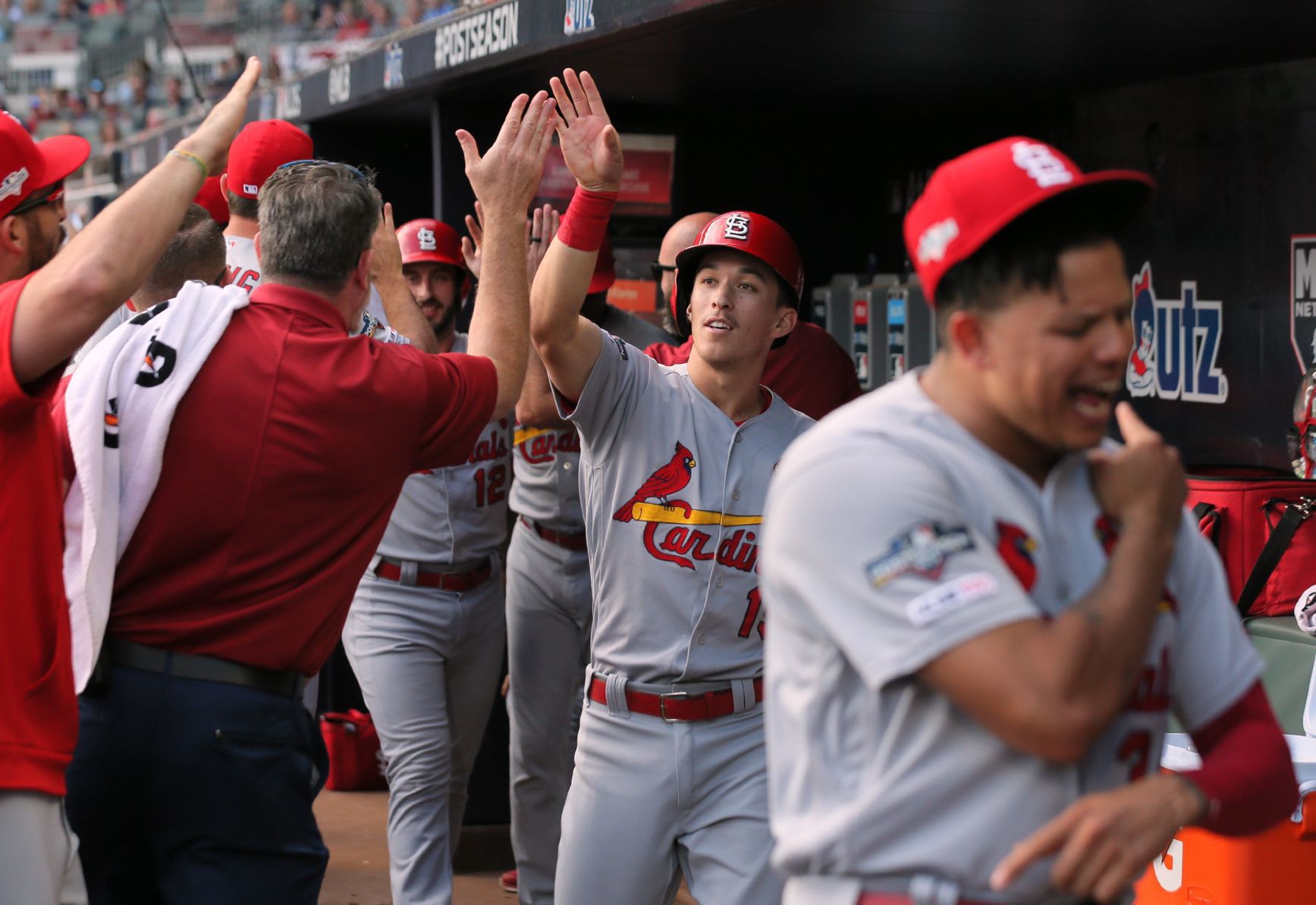 Edman high-fives after scoring in NLDS Game 5 vs. Braves